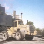 Heavy machinery near a factory