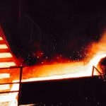 Molten metal flowing in industrial setting