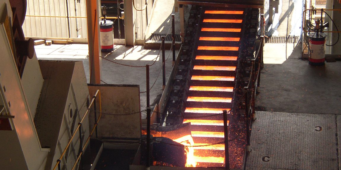 Molten metal on conveyor in steel mill