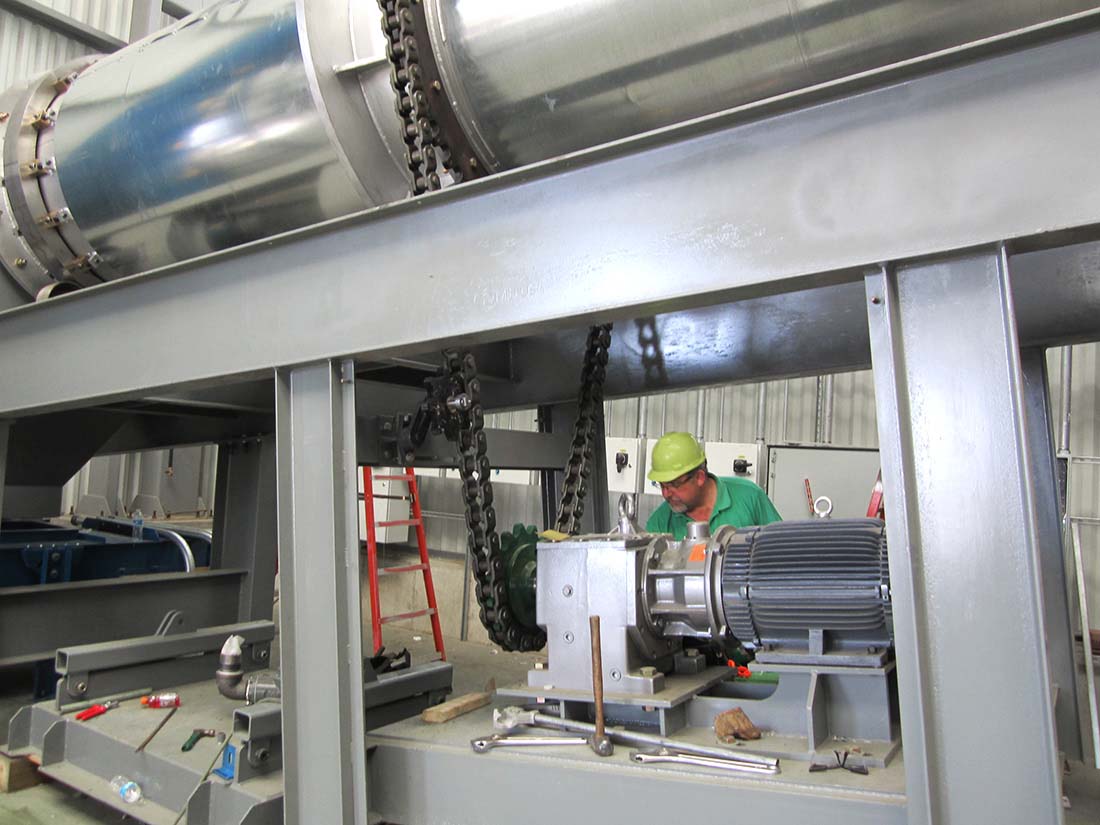Worker in hard hat near machinery
